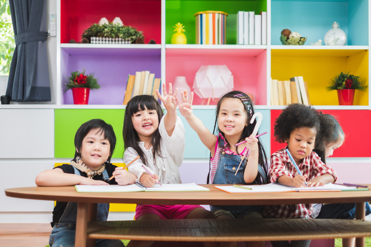 Group diversity kids studying at school, rising hands for answer and question in classroom, kids education concept